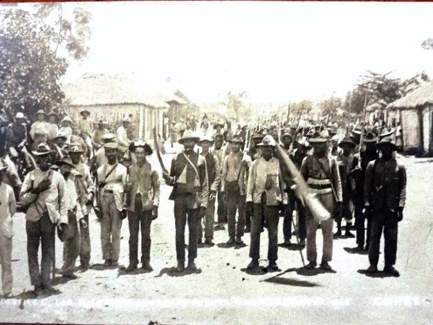 Comision de Paz Copey Black and white post card with a view of the insurect forces in front of the Peace Commission, Copey 1906. Dimension is...