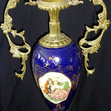 Amphora - Anfora Large in a classical blue color with a romantic scene in the center, and handles and base in bronze, and with a base in brown marble, and with a large size of...