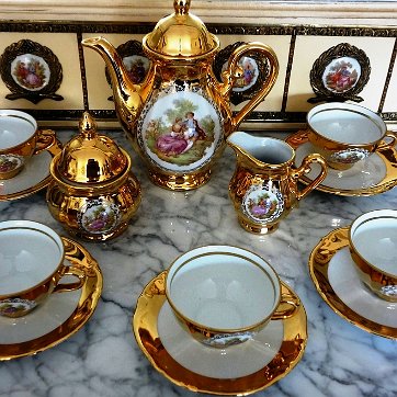 China - Vajilla Horst Kuba Bavaria a set with five cups and plates, sugar and cream bowls, and tea or coffee pot, decorated in 24 Karat gold, and a romantic scene in the...
